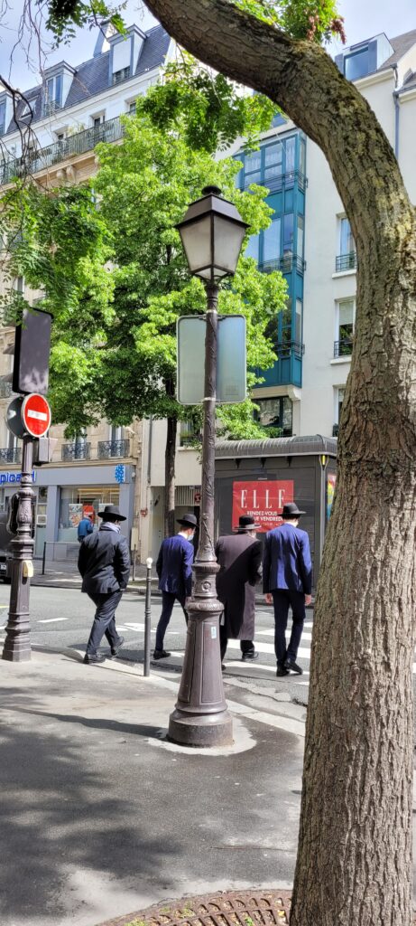 Four jewish men talking in the street of jewish Paris 2022
