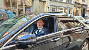 picture of a man driving a mercedes car in a street in Paris